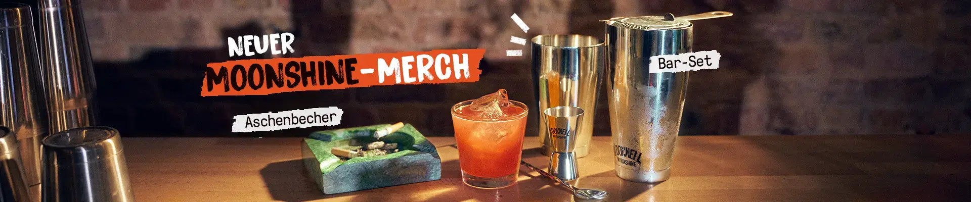 Das Desktop Banner für das O'Donnell Moonshine Merch Drop mit dem Aschenbecher und dem bar Set.